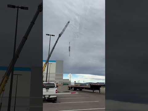Kran mobile crane setting a high-voltage insulator stack